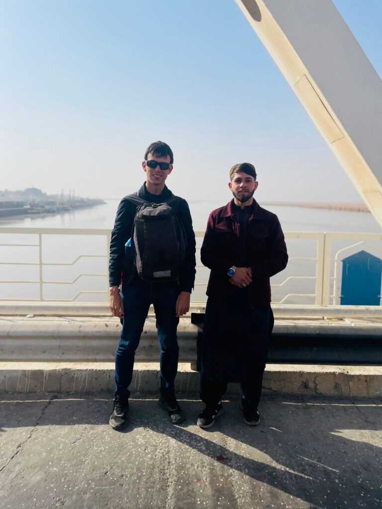 Alex meeting an Afghan man on the Friendship Bridge between Uzbekistan and Afghanistan.