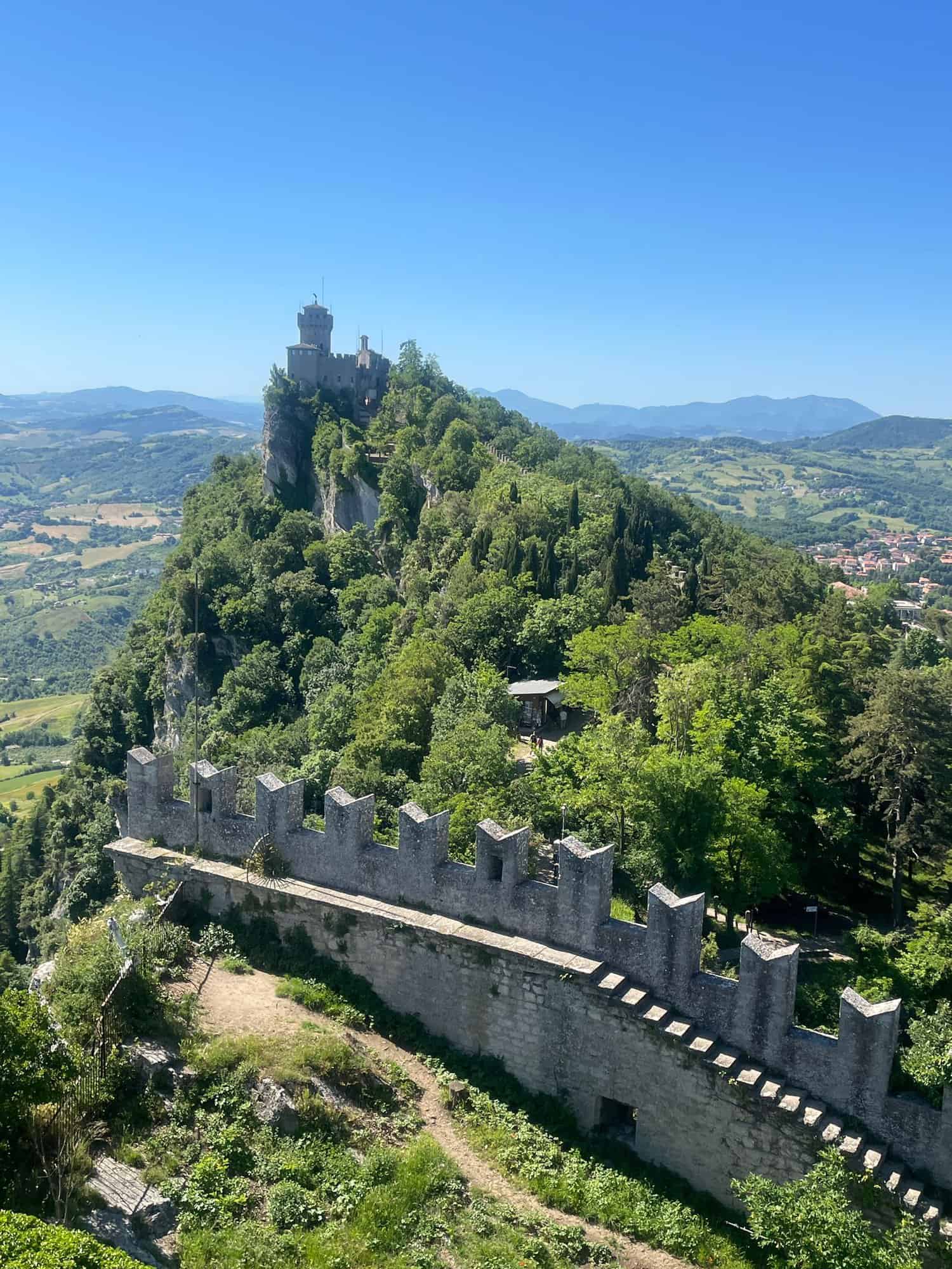 The Cesta Tower in San Marino, on top of the rockface on which the historic centre is built, surrounded by a castle wall.