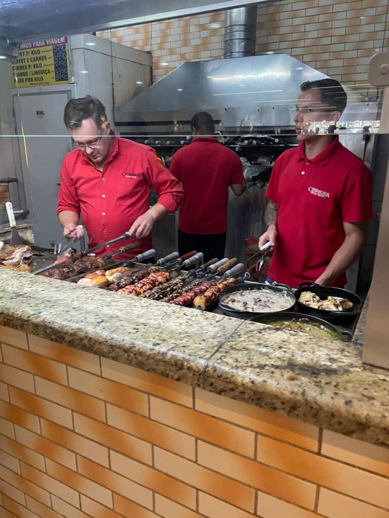 A churrascaria in Brazil, where a variety of meat is being served from the grill.