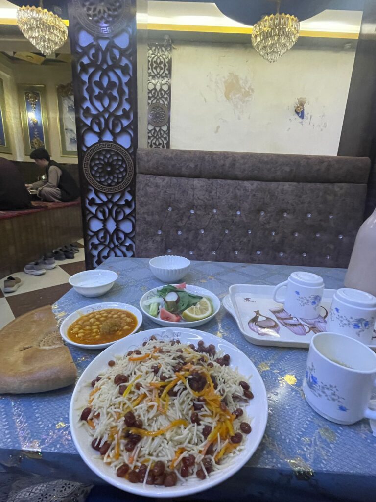 Kabuli pilao with a few side dishes in Afghanistan.
