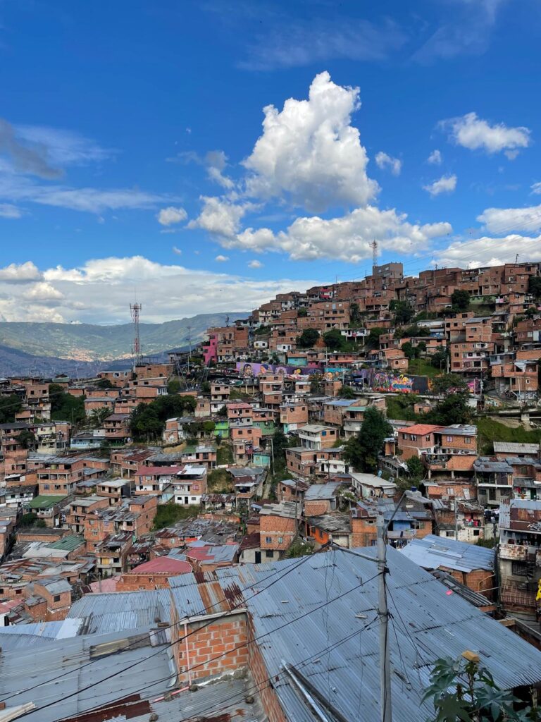 A series of small houses on a hillside which make up the Comuna 13 neighbourhood in Medellin, Colombia.