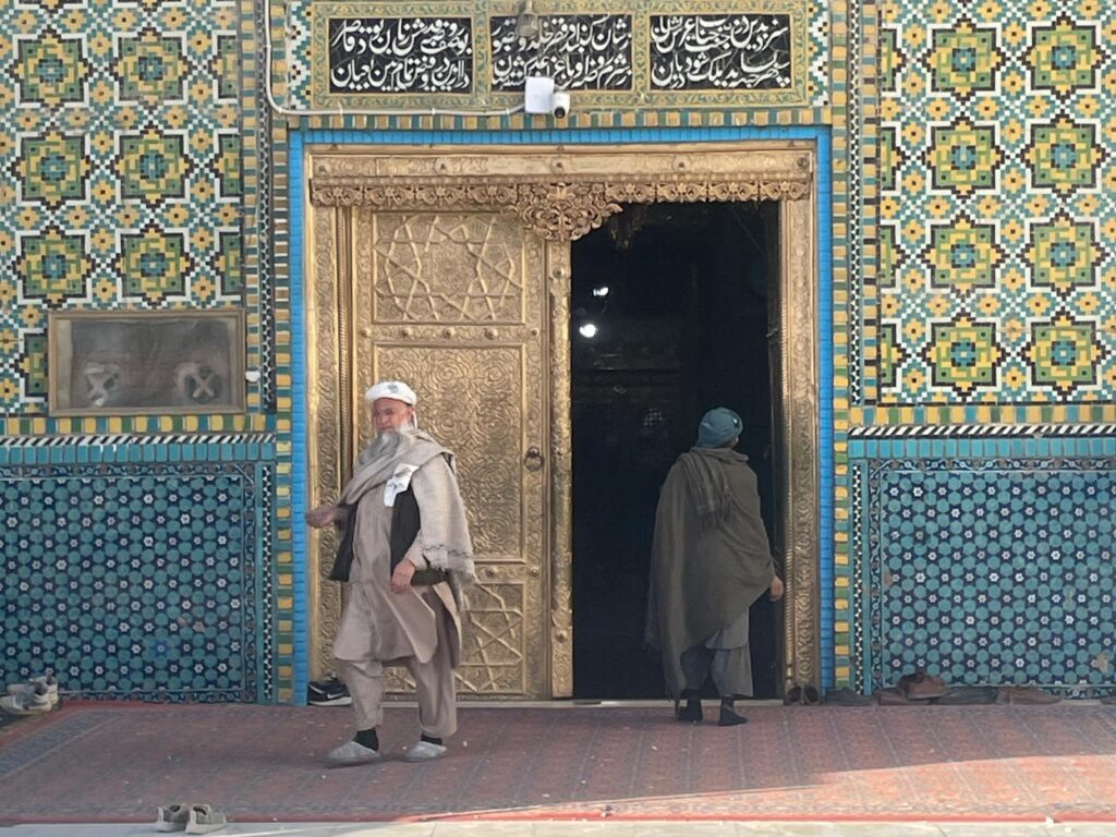 Two men at the entrance to the Blue Mosque in Mazar-i-Sharif, Afghanistan.