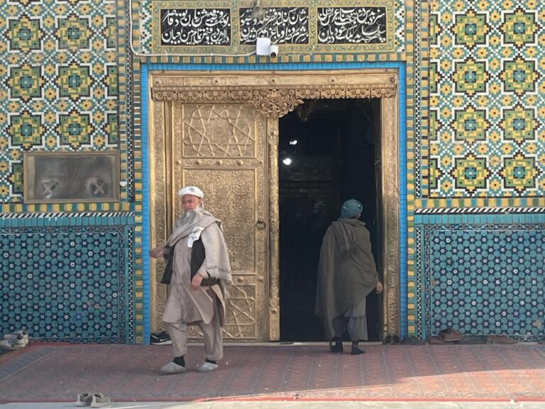 Two men at the entrance to the Blue Mosque in Mazar-i-Sharif, Afghanistan.