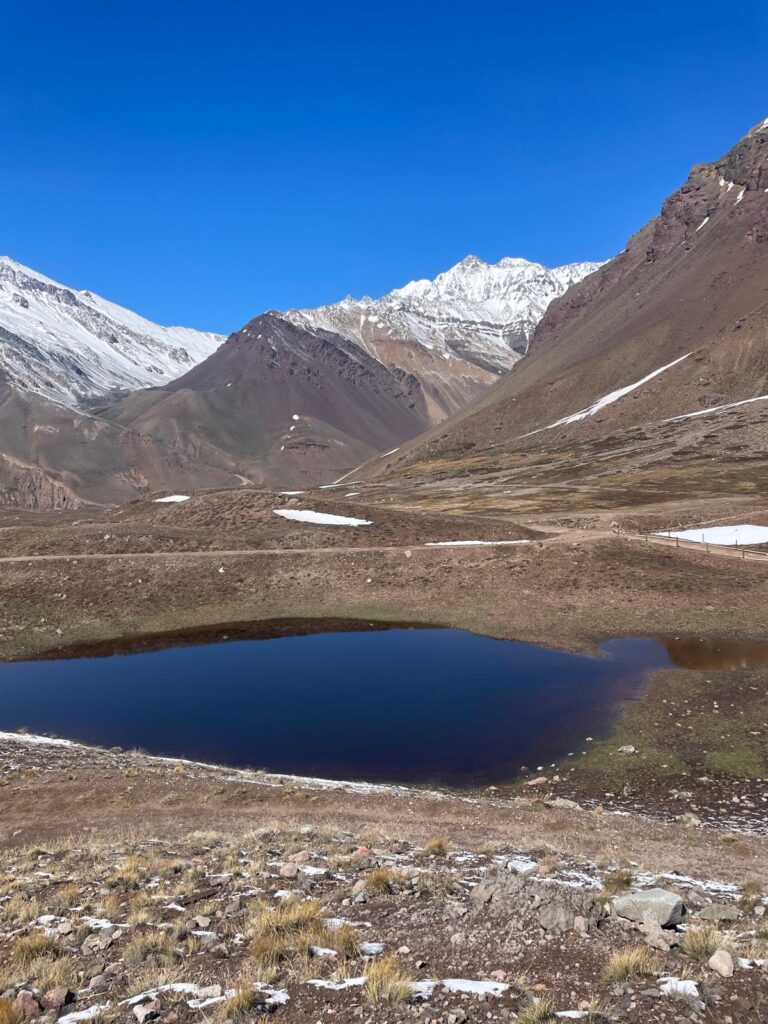 A lake in the middle of Argentina's Andes mountains, with Mount Aconcagua visible in the background.