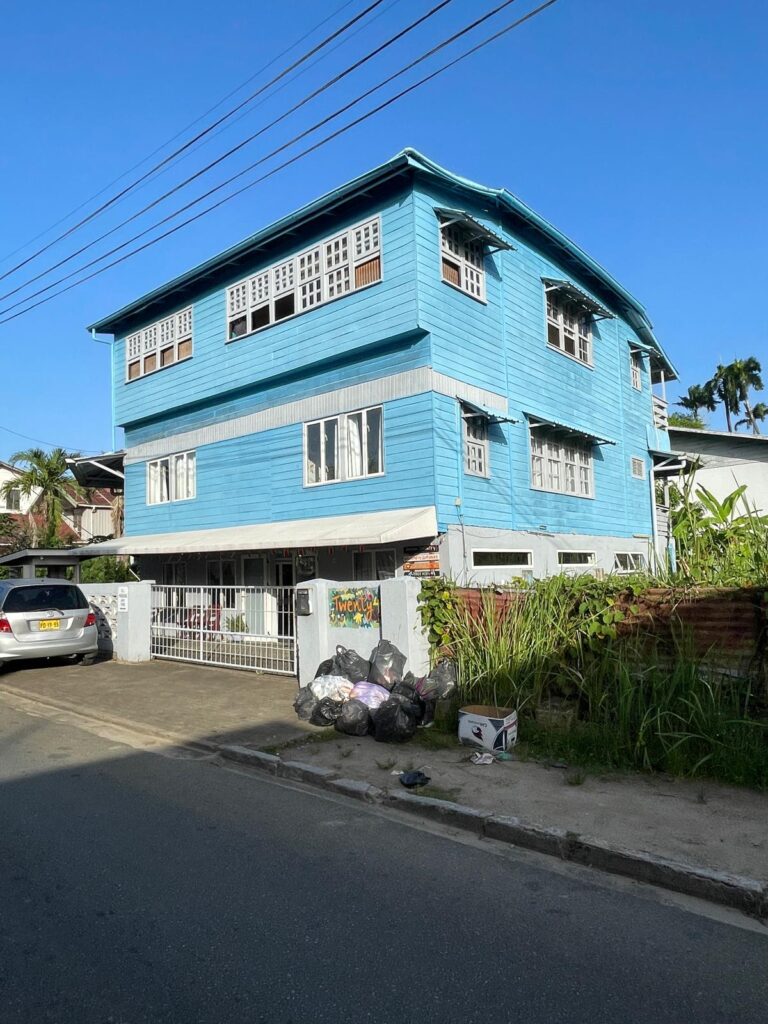 This blue building is Twenty4 Hostel in Paramaribo, Suriname.