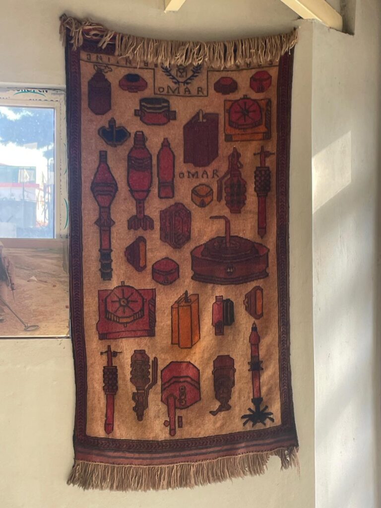 A war rug in Afghanistan. It gets its name from the war-themed images including grenades and mines on the rug.