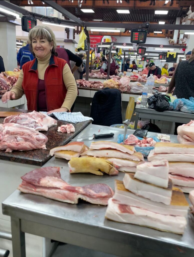 A lady smiles in the Green Market