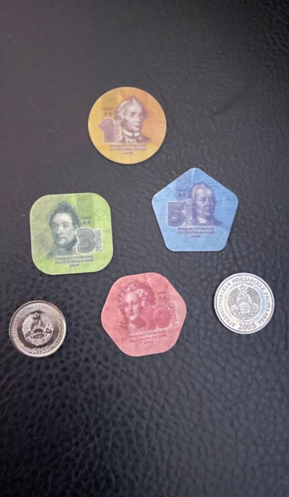 Transnistria's token currency, with plastic coins worth 1, 3, 5 and 10 rubles. You can also see a couple of traditional metal coins with the communist star and hammer and sickle displayed on them