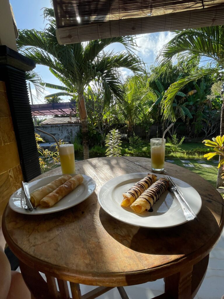 Breakfast pancakes in Bali, with trees in the background