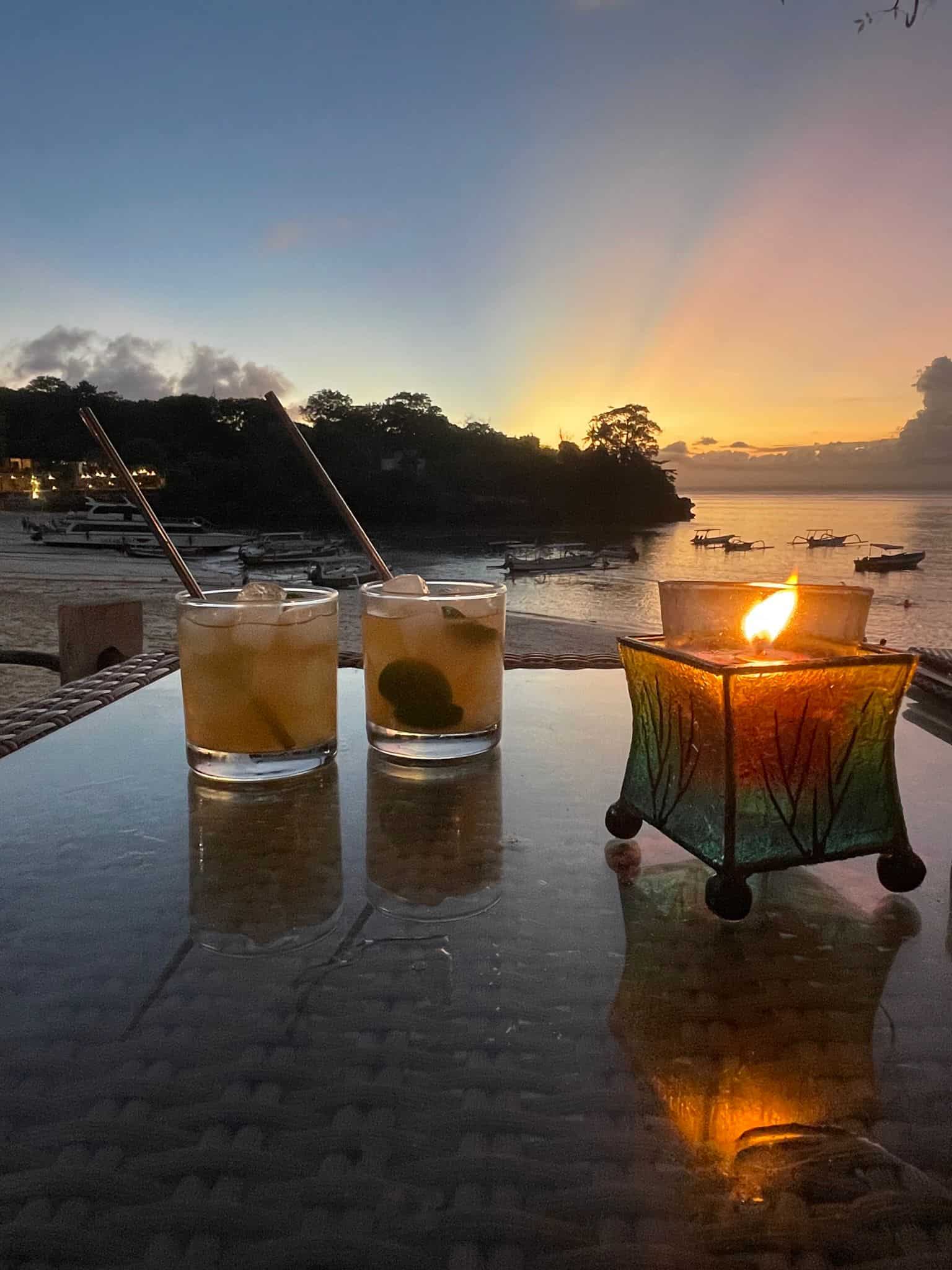 Candles at sunset by the sea in Nusa Lembongan, Indonesia