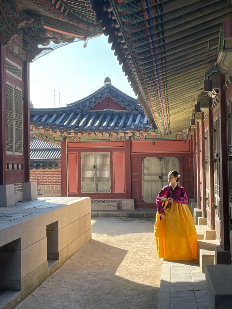 A lady wearing a traditional South Korean garment called a hanbok outside Gyeongbokgung Palace in Seoul