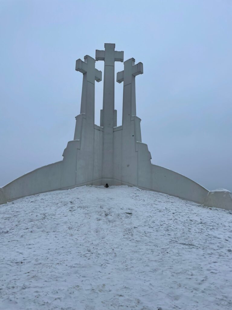 The Three Crosses Monument in Vilnius. This white statue of three crosses is surrounded by snow.
