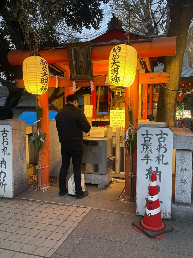 A man praying at a Shinto shrine