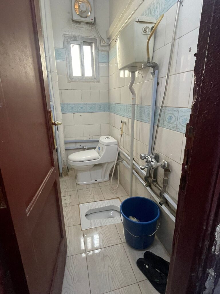 The bathroom at my hotel in Medina, the unnamed building near the Prophet's Mosque included a bucket shower and squat toilet alongside a more western-style toilet