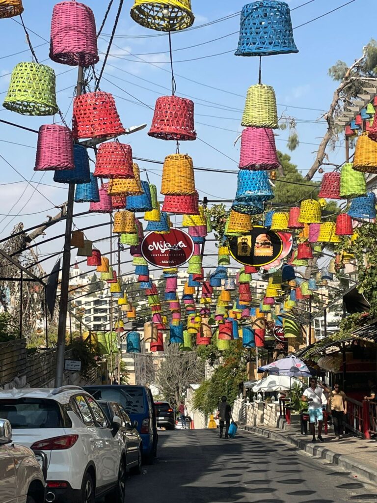 Colourful lanterns hanging above the road in Amman's famous Rainbow Street