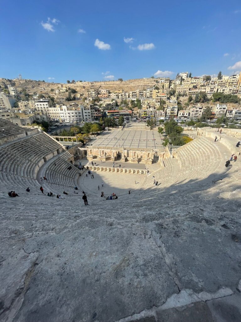 Amman's Roman Theater from the top, with views overlooking many of the city's buildings situated on hills