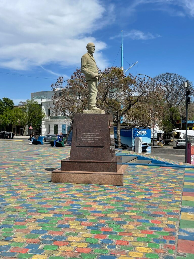 A statue of artist Benito Quinquela Martin on multi-coloured paving stones in La Boca, Buenos Aires