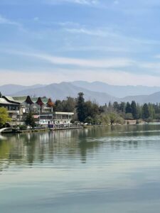 A lake in the middle of Parque General San Martin, Mendoza, Argentina. The water ripples as the sun shines down, with mountains providing the perfect backdrop