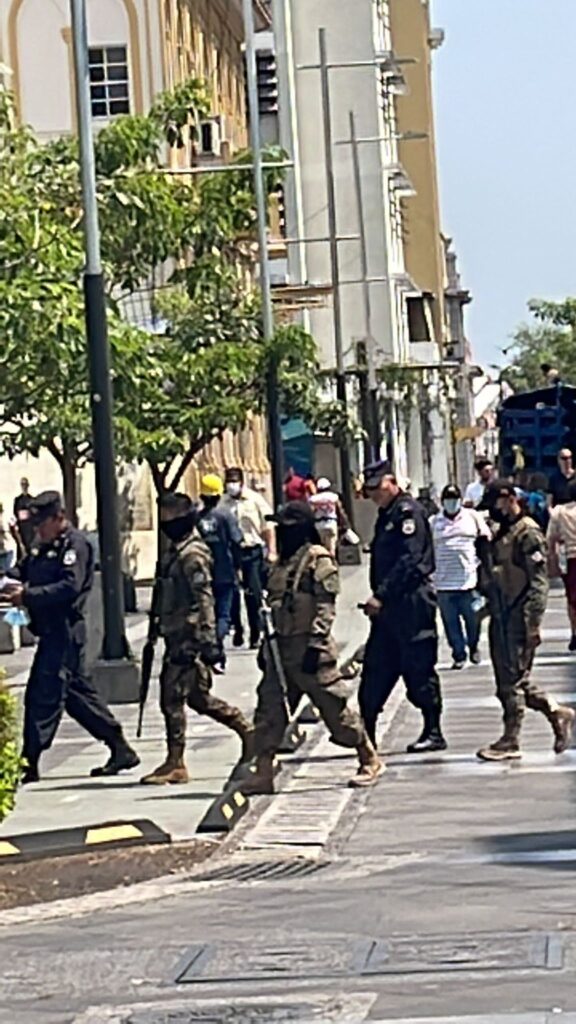 Armed guards patrolling the streets of San Salvador with large guns in broad daylight