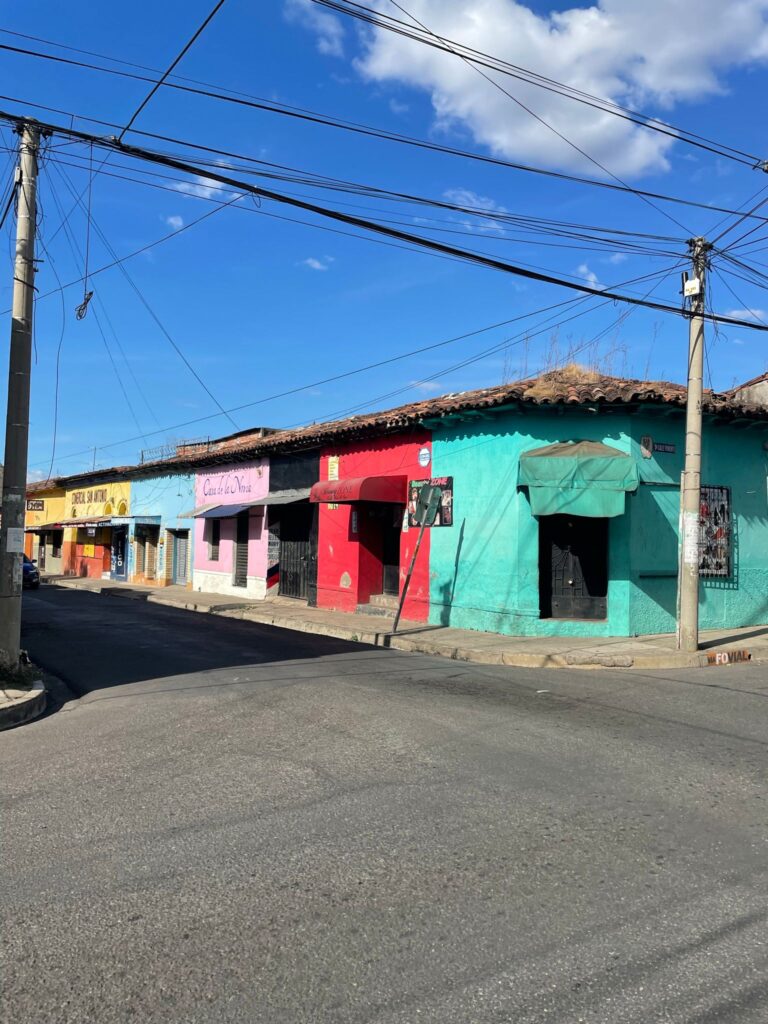 Yellow, blue, pink, black, red and turquoise-coloured colonial-style buildings in Santa Ana, El Salvador.