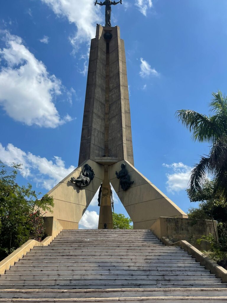 This tall monument is of a stone pillar with three 