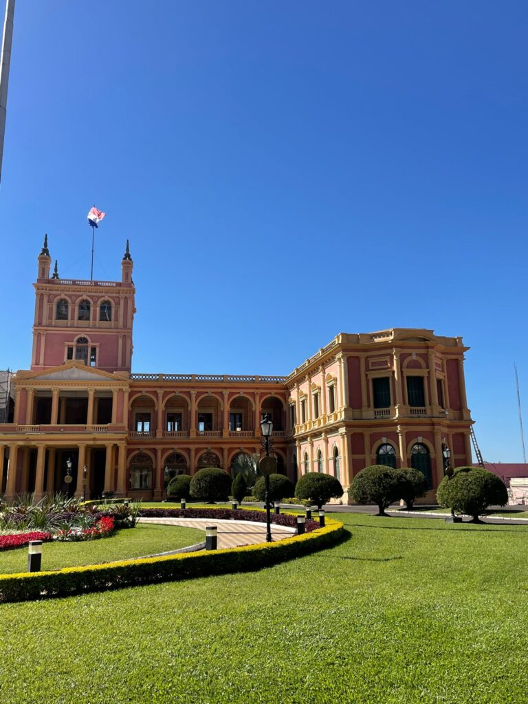 Palacio de los Lopez, the workplace of Paraguay's president in Asuncion. It is a pinkish-coloured building with gree grass outside