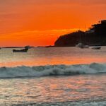 A bright orange sunset over the waters of San Juan del Sur in Nicaragua.
