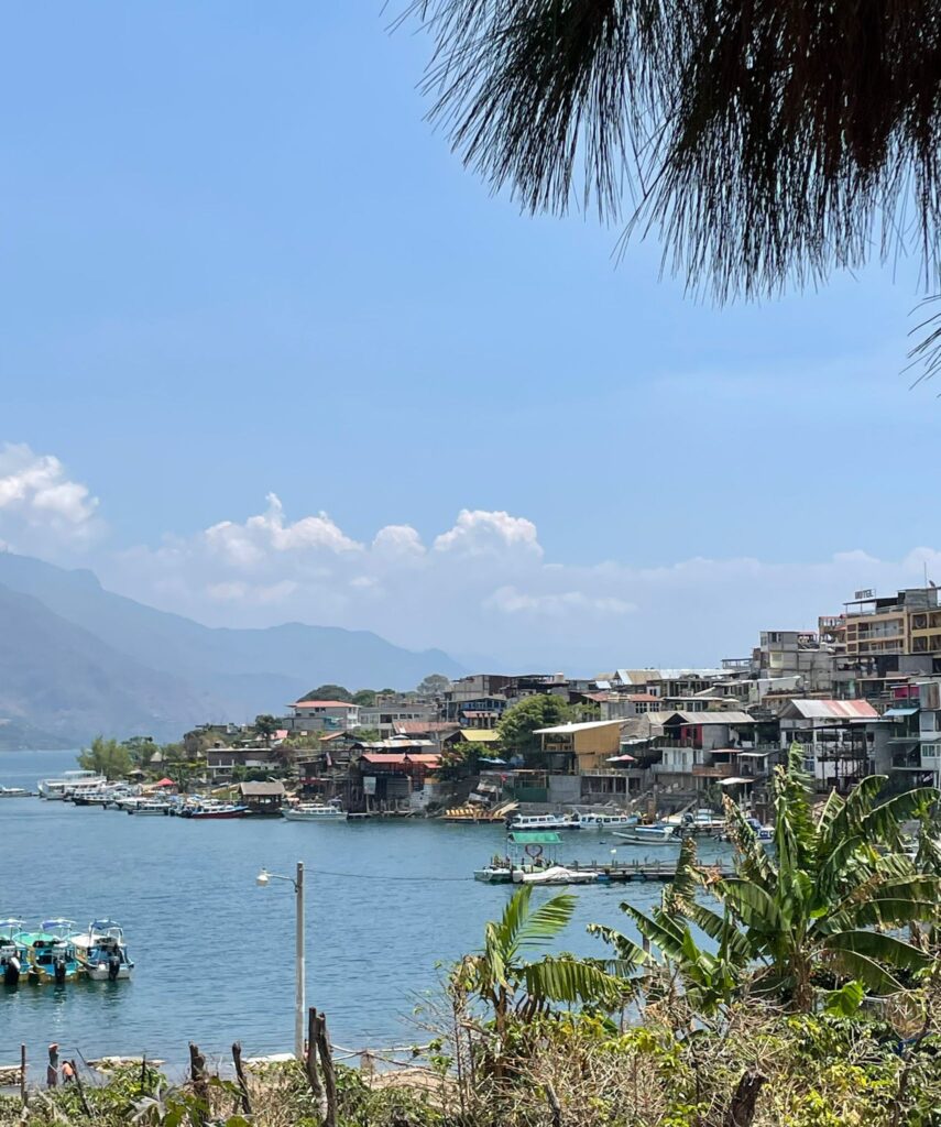 Many buildings and boats on the edge of Lake Atitlan in Guatemala, from the small town of San Pedro la Laguna