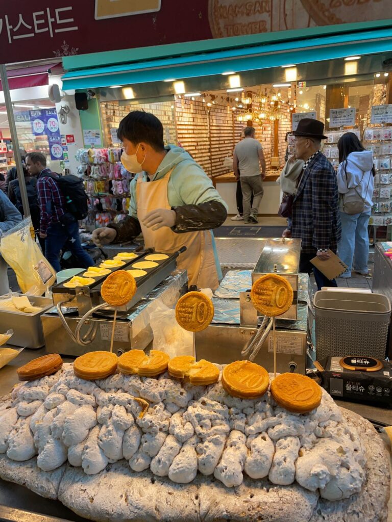 A series of pastries at Myeongdong's street markets. They are imprinted with the number 10 and the words "Seoul Namsan Tower" to make them look like coins.
