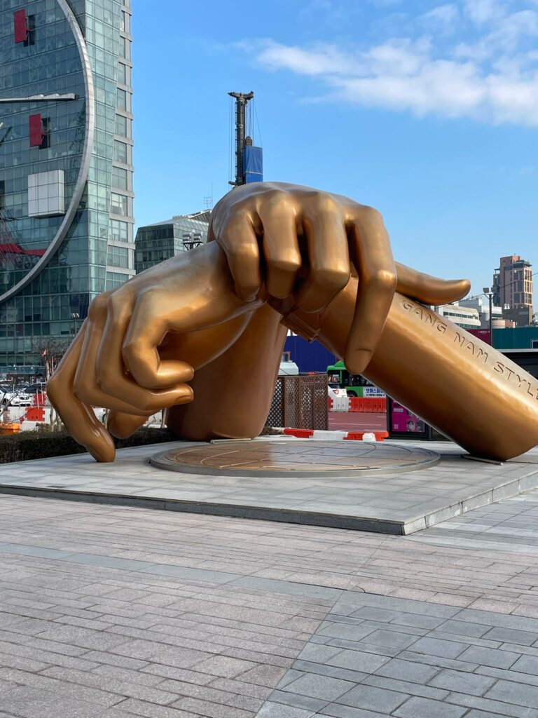 The Gangnam Style statue in Seoul, South Korea. It shows two bronze hands overlapping to perform the "Gangnam Style" dance which was popular alongside the 2012 song