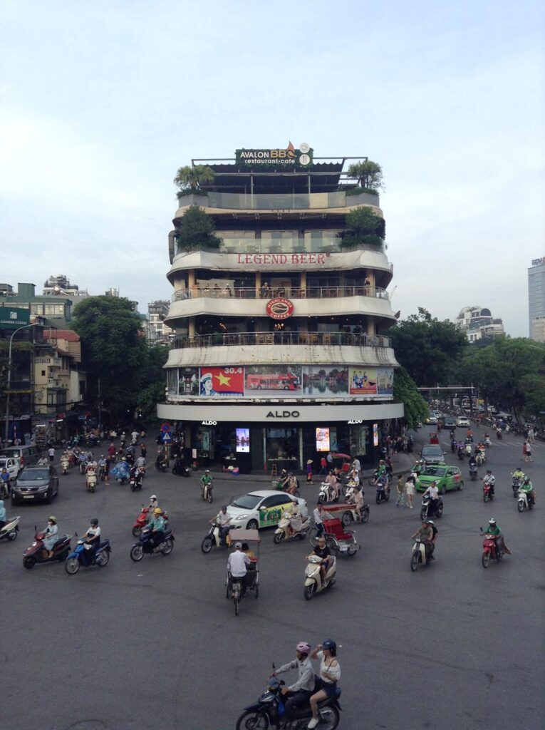 Dozens of motorbikes whizzing past a building in central Hanoi, Vietnam