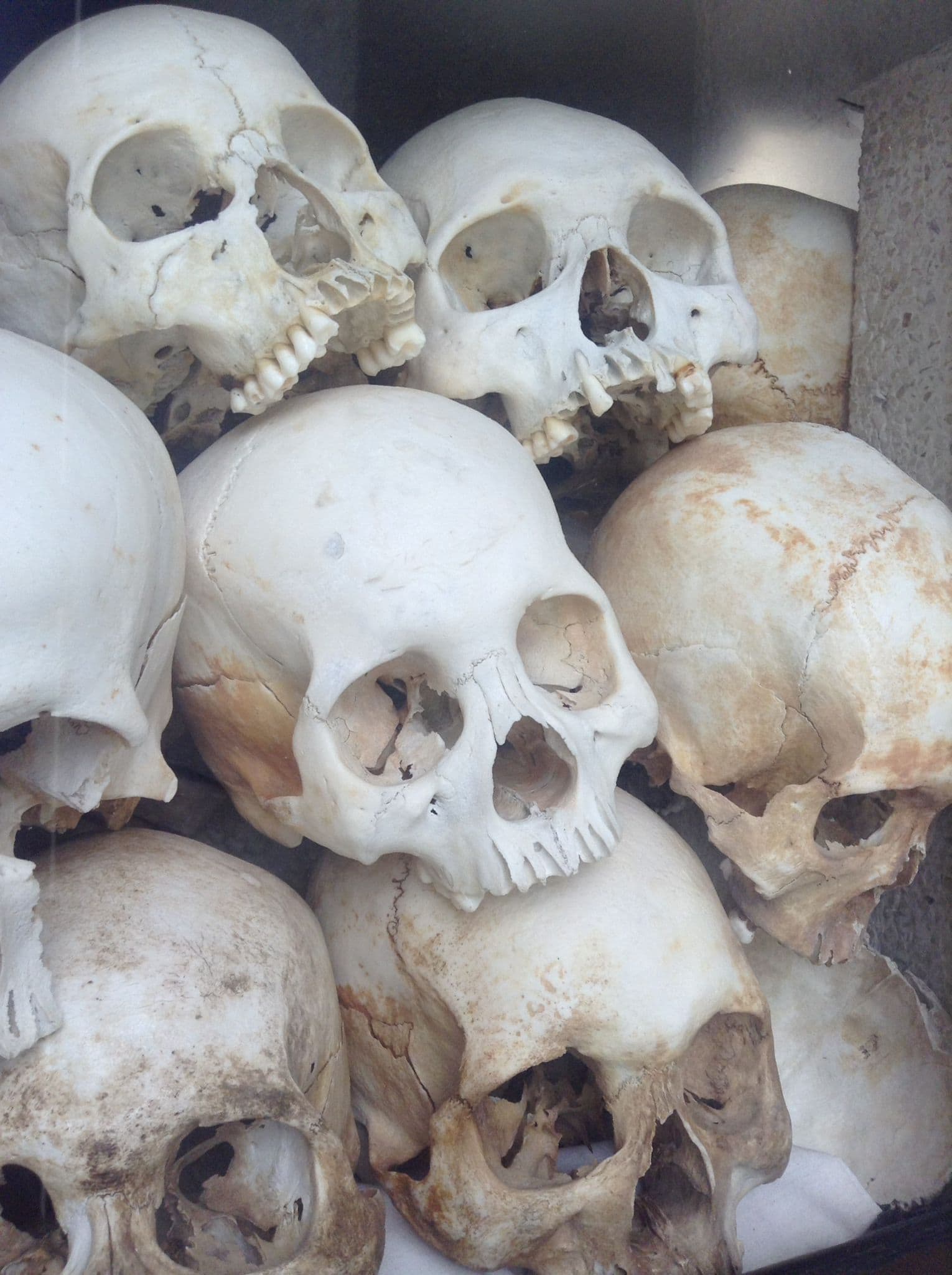 A tower of skulls stacked on top of each other at the Choeung Ek Killing Fields in Phnom Penh, Cambodia