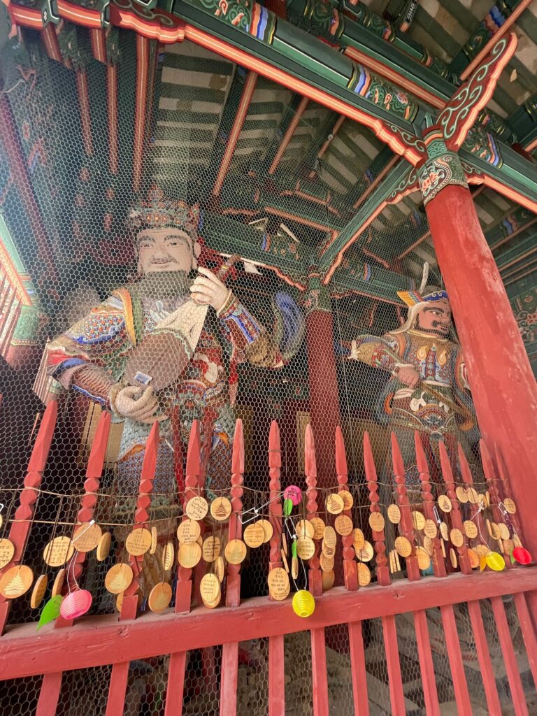The Four Heavenly Kings Gate at Beopjusa Temple in South Korea. Pictured are Dhrtarastra King of the East, playing a lute (on the left), and Virudhaka King of the South with a large sword (on the right)