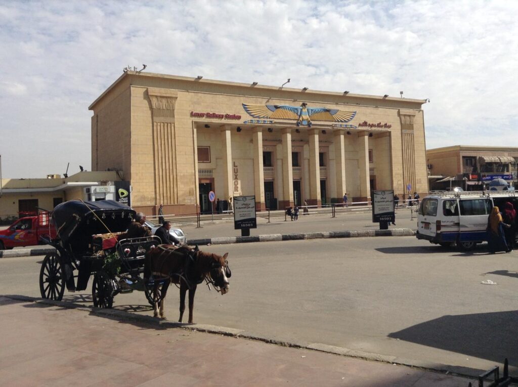 The entrance to Luxor's train station in Egypt. You can see a horse and cart in the foreground: one of the most common forms of transport for tourists in Luxor