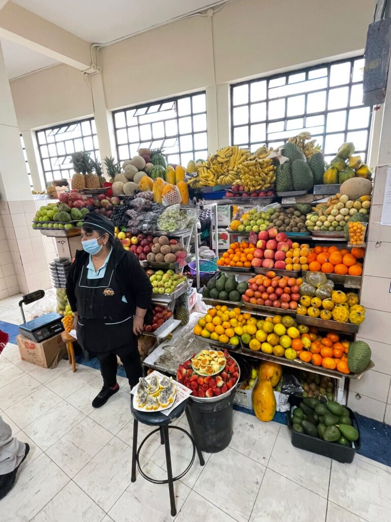 A lady selling all sorts of colourful fruits in Quito, Ecuador