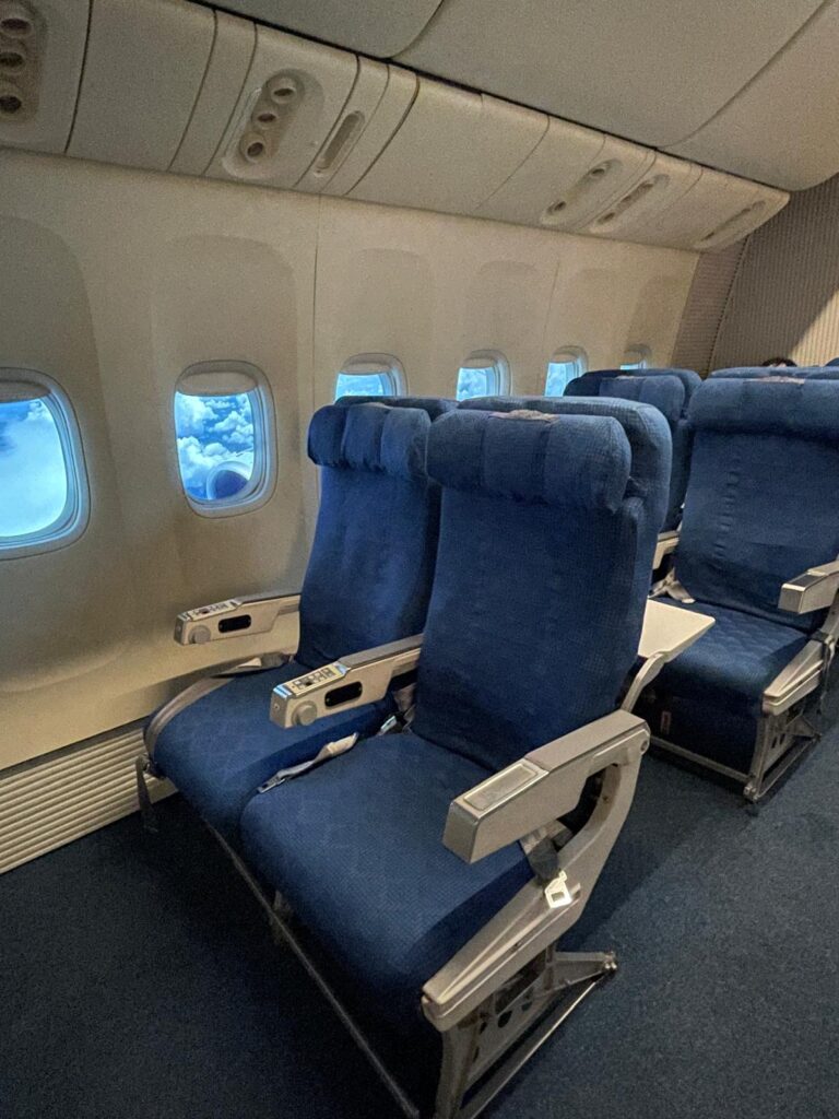 The aeroplane-style seating at Boing Cafe in Seoul. You can see plane-style seats, and even windows through which you can see "clouds"