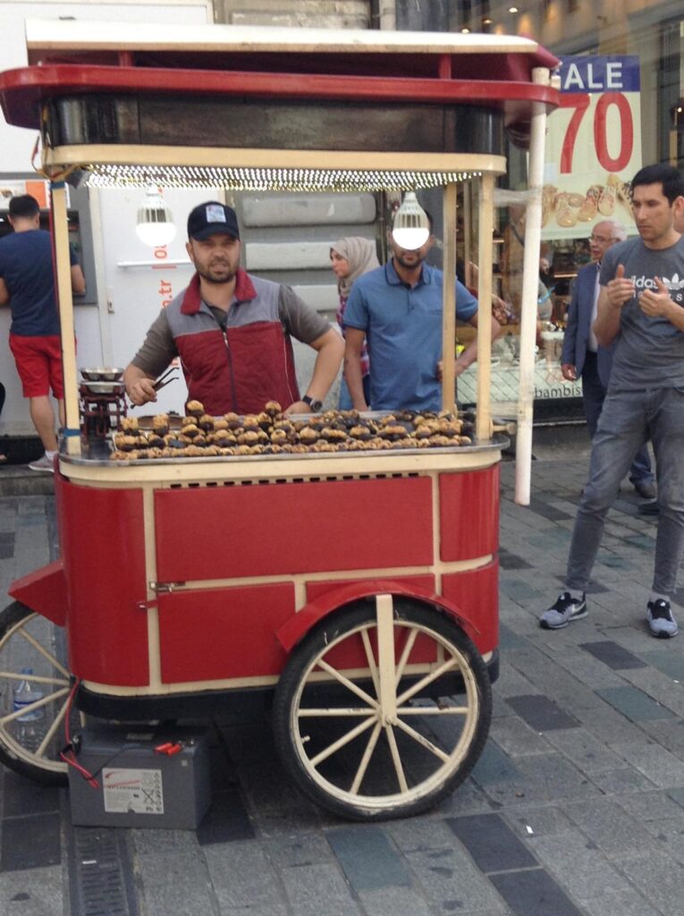 A man selling local street food at his cart on the streets of Istanbul