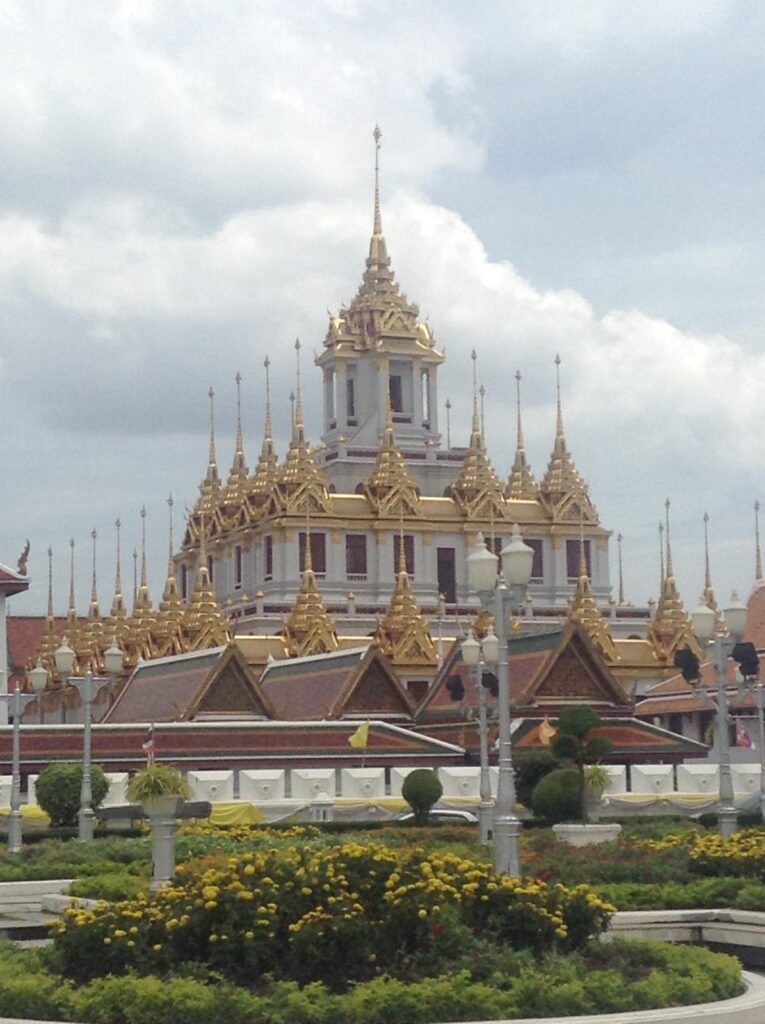 Loha Prasat, a white building with numerous golden spires surrounding the roof