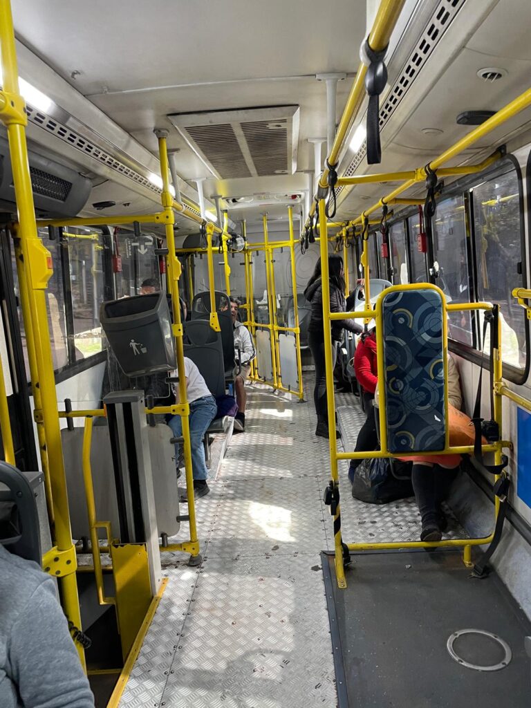 A bus in Asuncion, Paraguay. There are a small number of seats, with a metal walkway in the middle