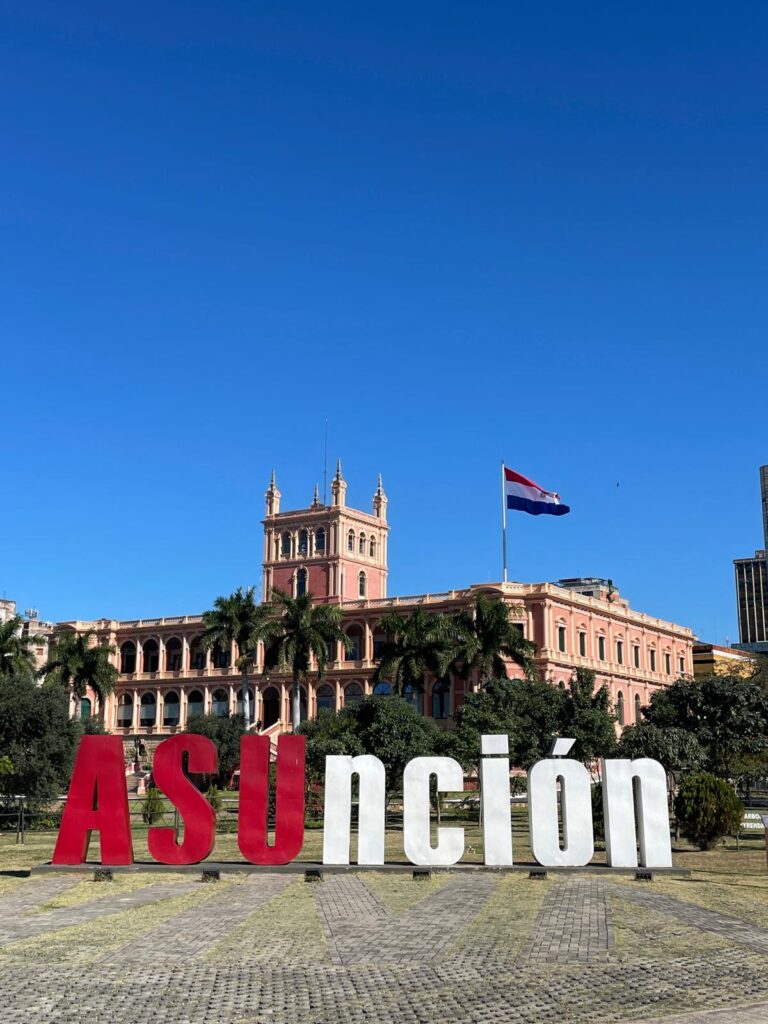 The president's palace, Palacio de los Lopez, in Paraguay's capital Asuncion with a Paraguayan flag beside it. In front is a sign which says 