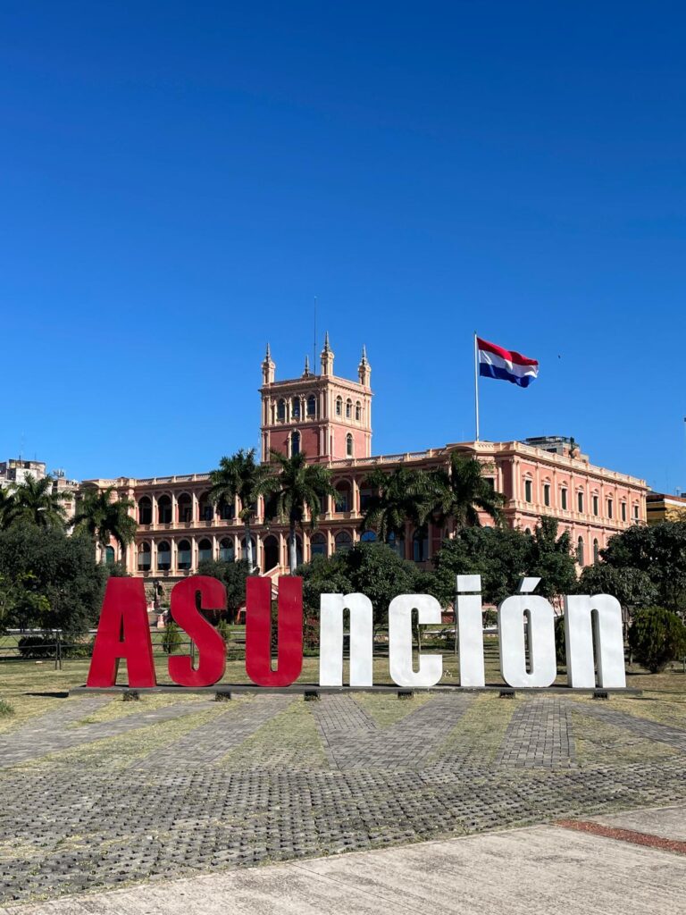 The president's palace, Palacio de los Lopez, in Paraguay's capital Asuncion with a Paraguayan flag beside it. In front is a sign which says 