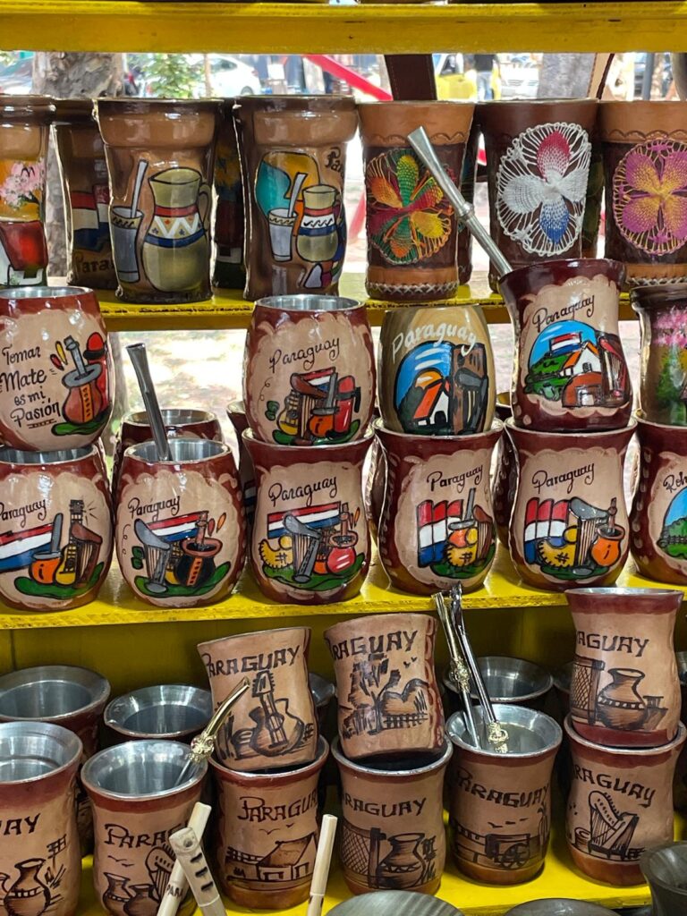 A series of colourful mate gourds with the word "Paraguay" and local branding including the Paraguay flag