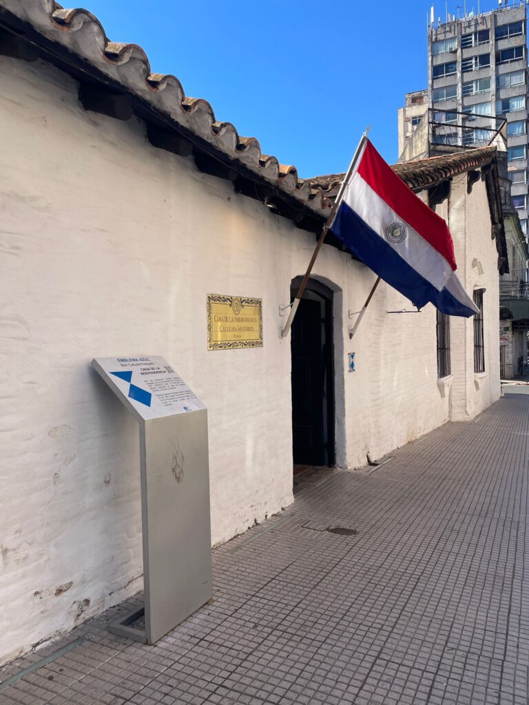 Paraguay's Independence House, a small building with two Paraguayan flags outside the entrance