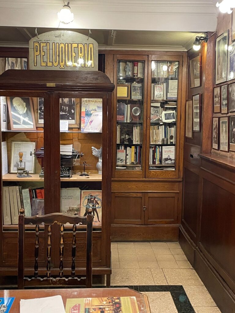 The library room at Buenos Aires' Cafe Tortoni, with a case containing books, photos and a typewriter. Behind it is another case full of books