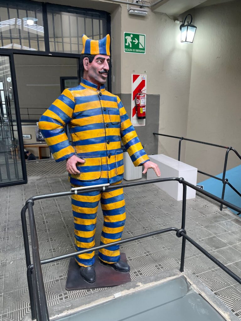 A statue of a prisoner wearing yellow and blue stripes at Ushuaia's Prison Museum in Southern Argentine Patagonia