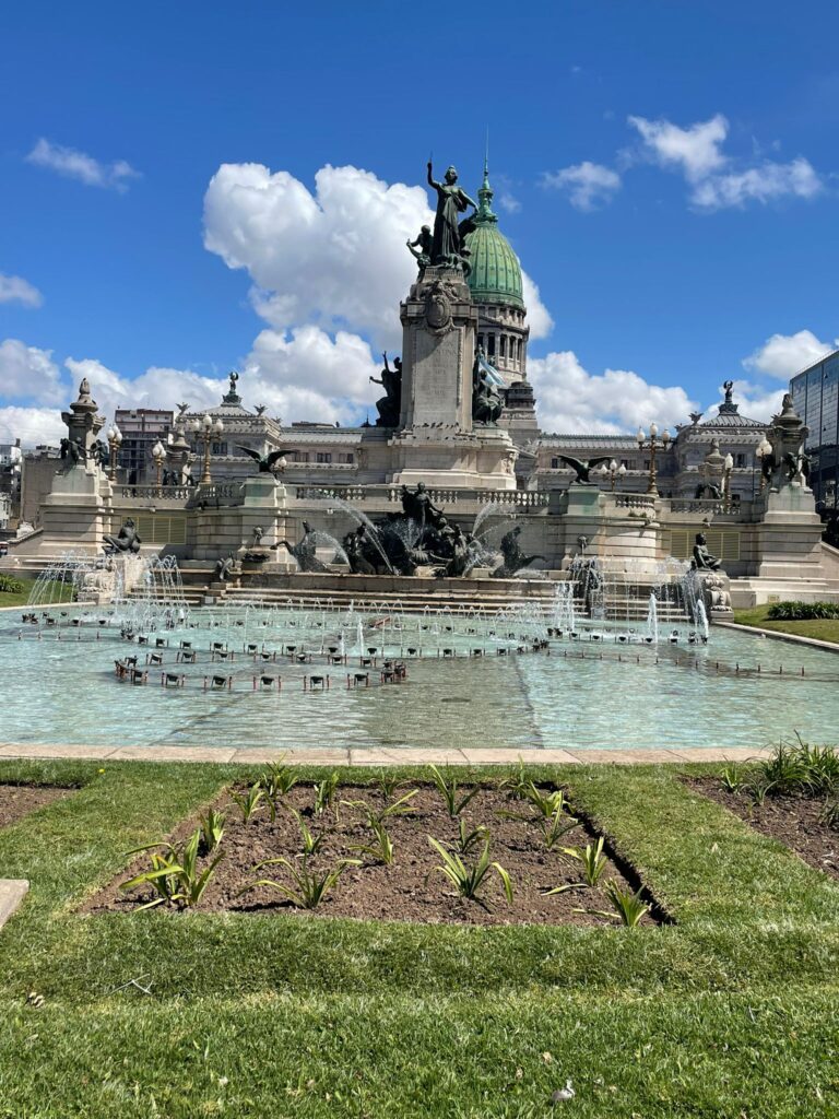 Buenos Aires' Palacio del Congreso, behind a fountain with a large statue in the middle