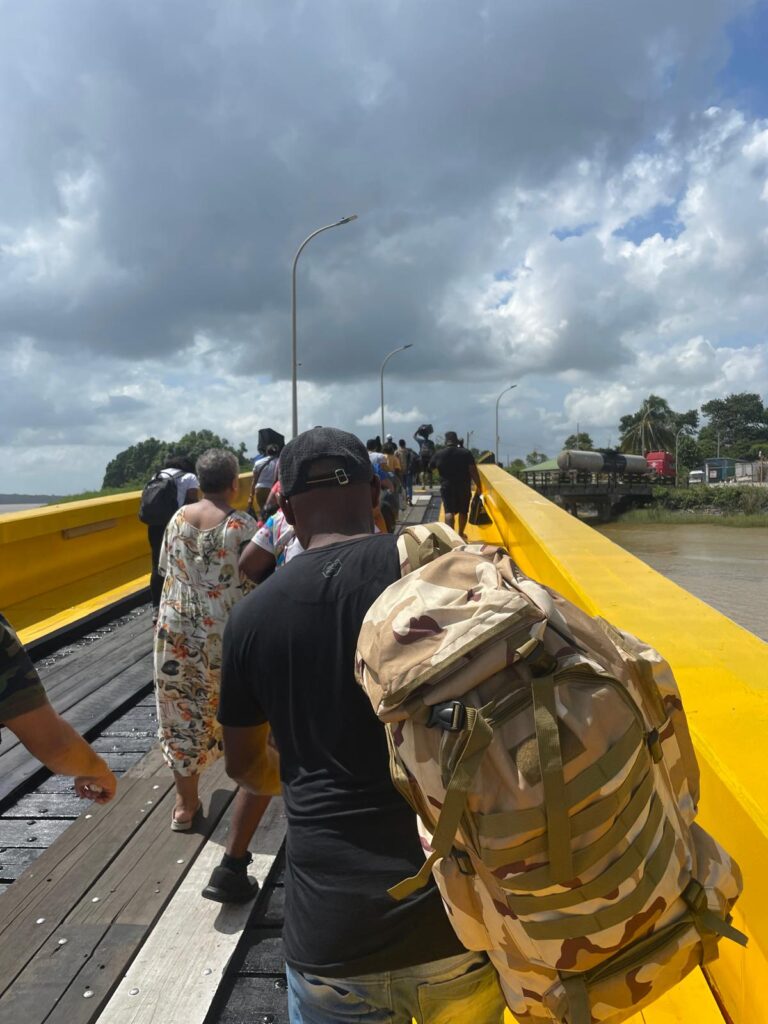 A group of locals from Suriname and Guyana walk off the ferry between the two countries during the near-12-hour journey from Paramaribo to Georgetown