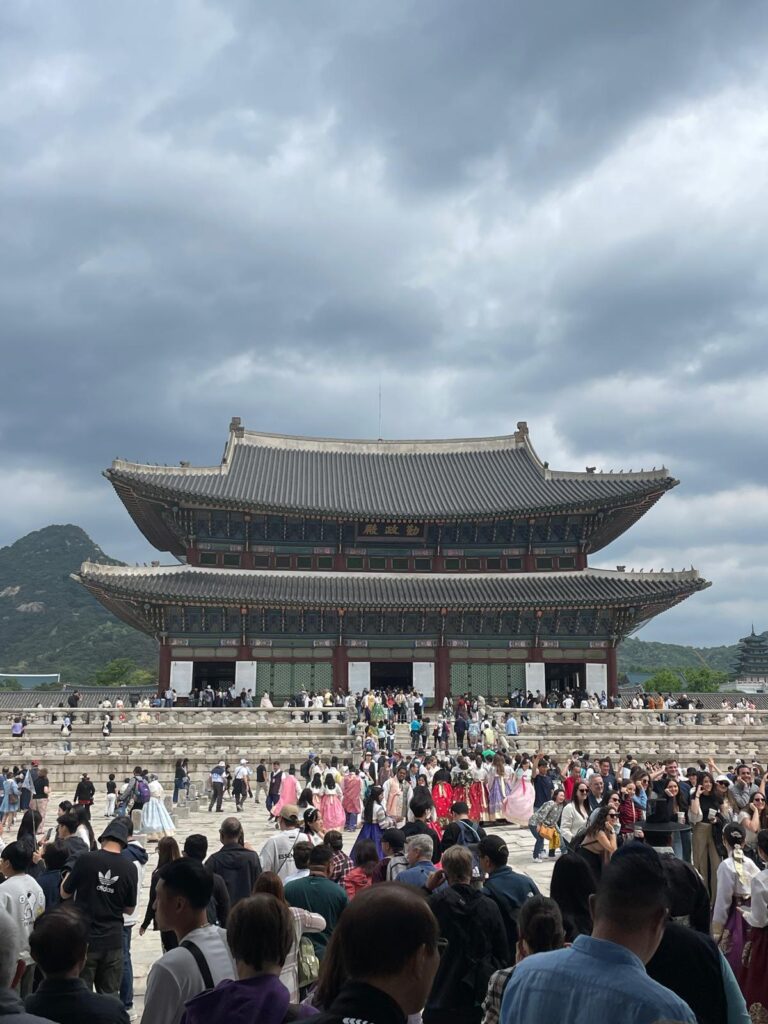 Hundreds of visitors, with many wearing traditional Korean hanboks, gathering outside popular Gyeongbokgung Palace in Seoul