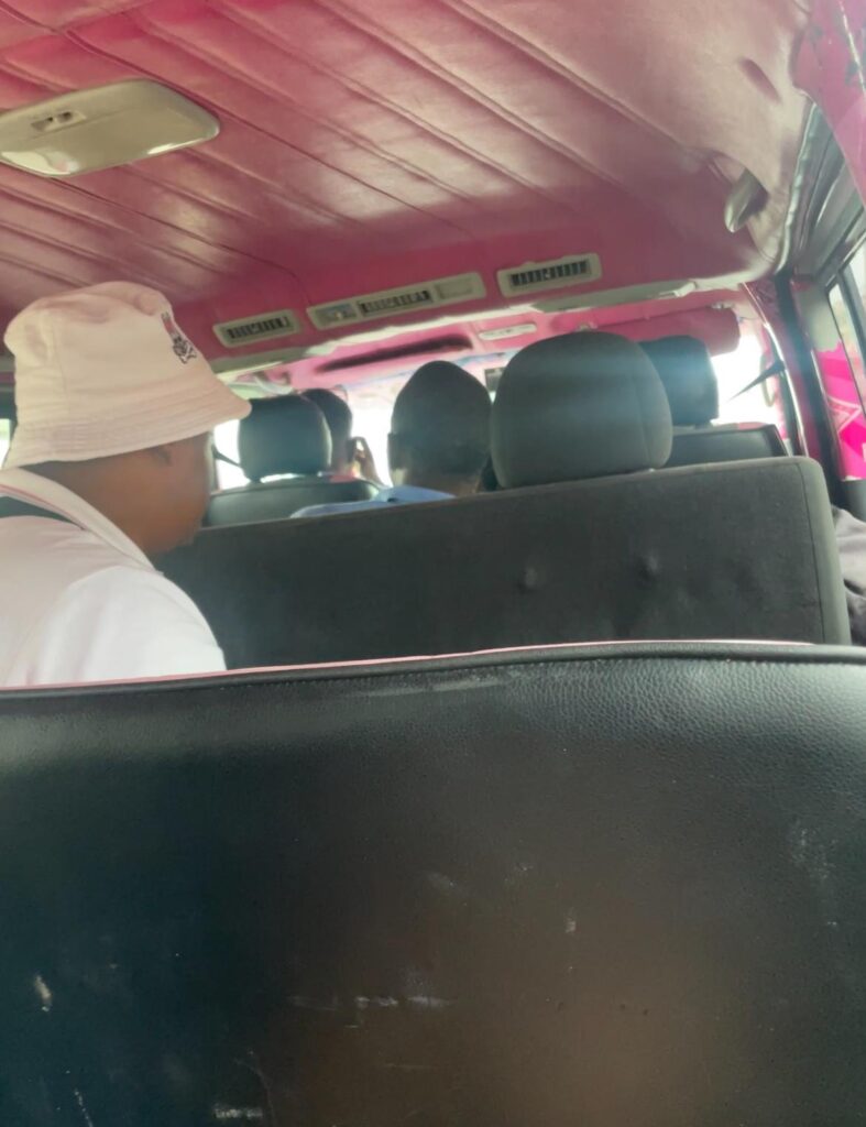 The inside of an uncomfortable minivan used as transport from Guyana's capital Georgetown to the border town of Molsen Creek. There are two men sat in front, as well as the driver