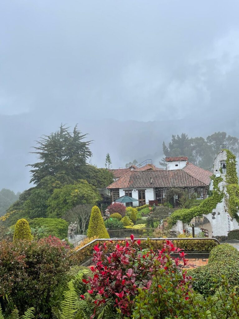 Lots of green bushes and trees adding some colour to foggy Bogota from the top of Monserrate